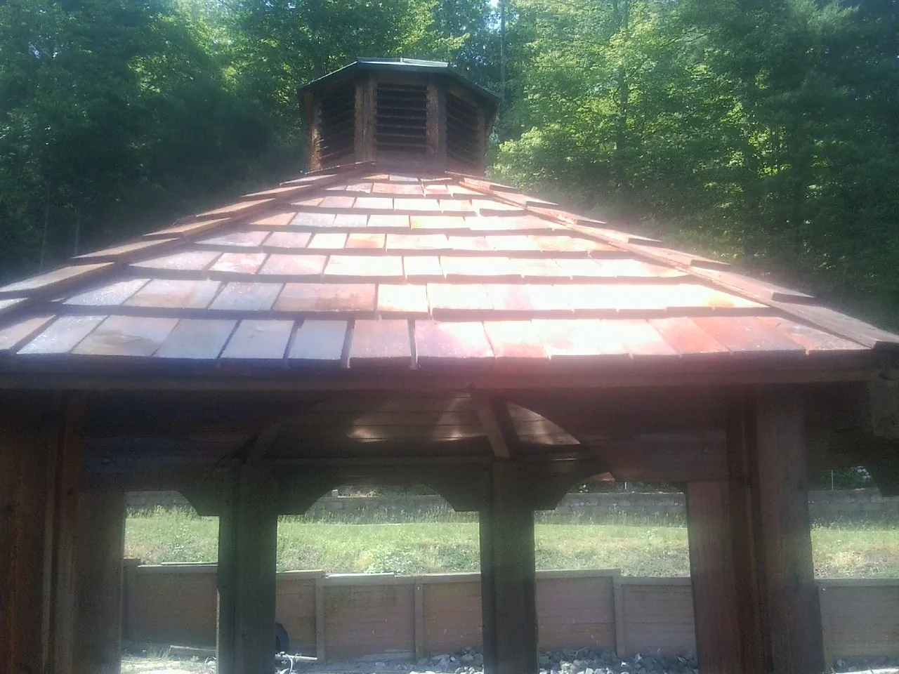 New cedar shake roof and cupola on a lakeside gazebo in Woodland